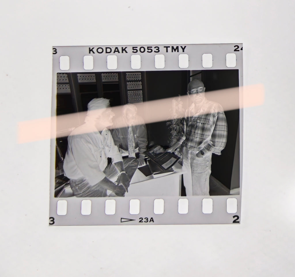 Original photographic negative of writers Joan Manuel Tresserras, Víctor Batallé, and Enric Marín meeting in an office, Premis Octubre Valencia 1994, 35mm film, rare.